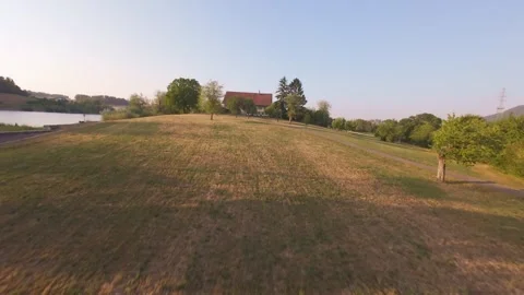 FPV Drone Doing a Barrel Roll in the Air at Sunset, Aerial Stunt Stock Footage 341237651