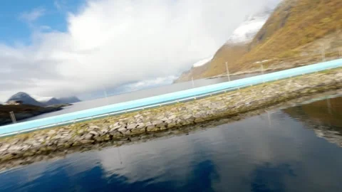 FPV Drone down mountain to fishing village of Husøy on Senja island in Norway 스톡 동영상 308729403