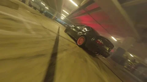 FPV Drone Drift Battle: Black-Red BMW vs Black BMW  Underground Stock Footage 327030491