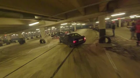 FPV Drone Drift of Blue BMW and Black-Red BMW in Underground Garage Stock Footage 327027987