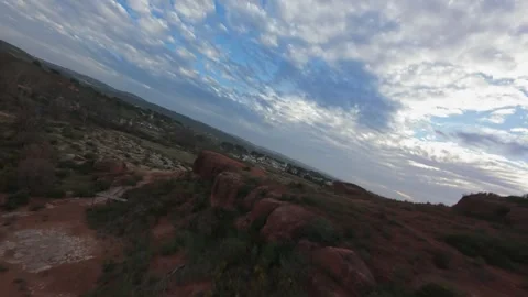 FPV drone dynamic banking flight over red clay ridges in Provence Stock Footage 335371385