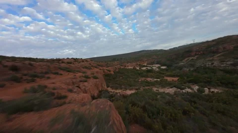 FPV drone dynamic low flight over red rocks landscape in Provence Stock Footage 335371396