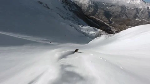 FPV drone extreme snowboarder freeride on snowboard jumping drop on snow Stock Footage 170705982