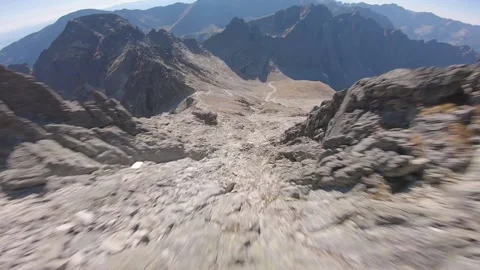 FPV drone fast flying through rocks in very high mountains Stock Footage 169280536