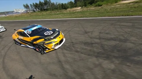 FPV drone flies around the drift car before the start of the competition 스톡 동영상 169410814