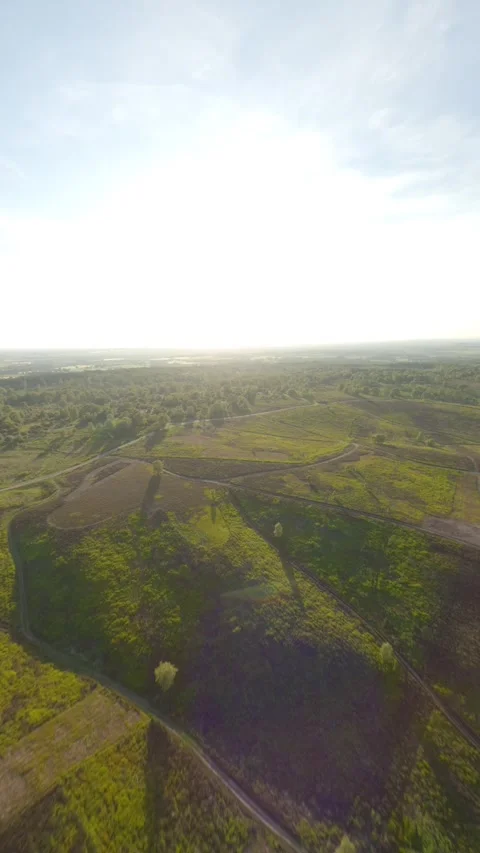 Fpv drone flies high over heathland and trails into the sunset Stock Footage 243755697