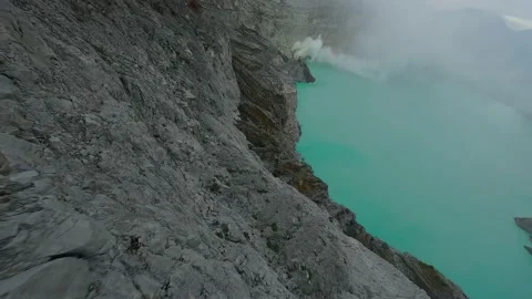 FPV drone flies over volcano Ijen and acid lake in Indonesian island Jawa Stock Footage 235691938