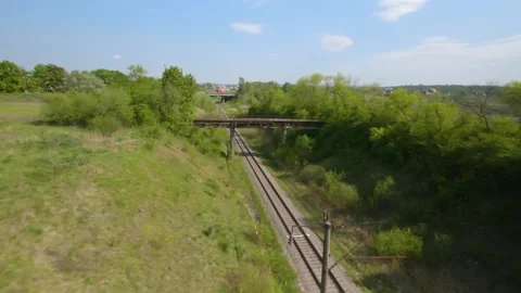 FPV drone flies quickly and maneuverable along the road on which the red truck Stock Footage 132087839