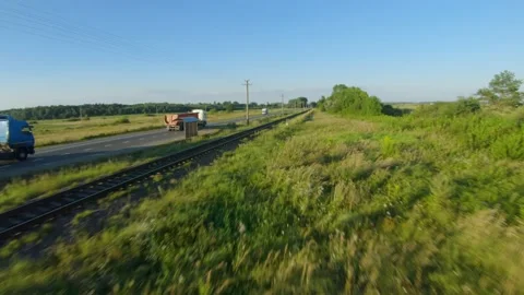 FPV drone flies quickly and maneuverable along the road on which the trucks are Stock Footage 138025687