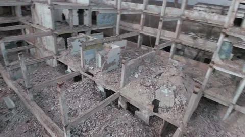 FPV drone flies quickly and maneuverable among abandoned industrial buildings Stock Footage 153975532