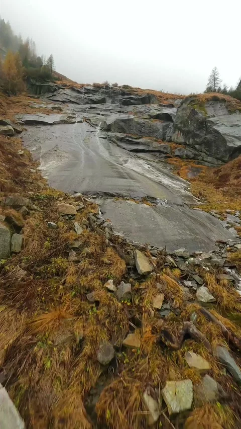 FPV drone flies quickly through the fog close to the stone surface. Austria Stock Footage 295296148
