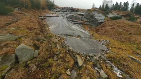 FPV drone flies quickly through the fog close to the stone surface. Austria Stock Footage 316419821