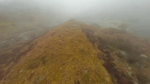 FPV drone flies quickly through the fog close to the stone surface. Austria Stock Footage 342959479