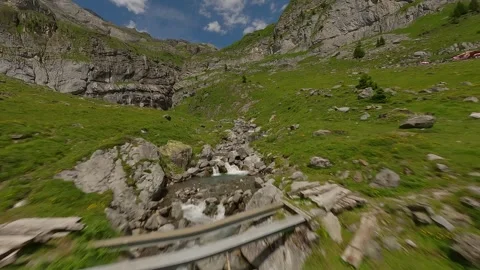FPV Drone Flight Along Alpine Stream Toward Waterfall Stock Footage 312818769