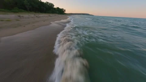 FPV drone flight along Kamchia Beach shoreline at sunset on the Black Sea. Stock Footage 342544494