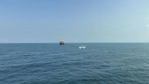 An FPV drone flight approaching a massive cargo ship Stock Footage 294067122