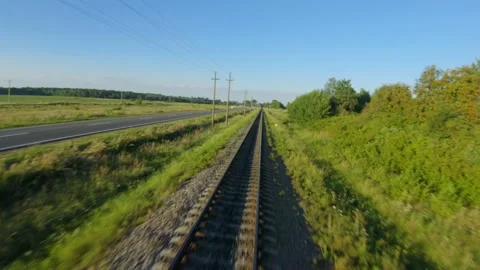 FPV drone flight fast and close to railroad tracks in a clear sunny day Stock Footage 138255086