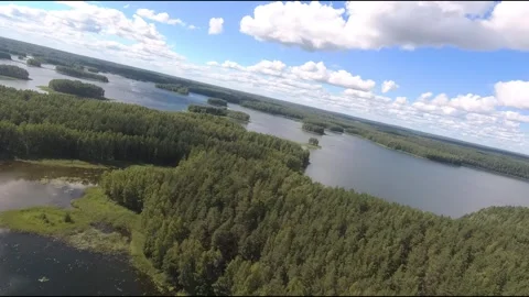 Fpv drone flight over blue lakes in a green forest over water Stock Footage 208609476