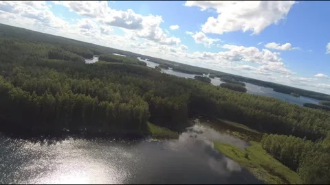 Fpv drone flight over blue lakes in a green forest over water Stock Footage 208609639