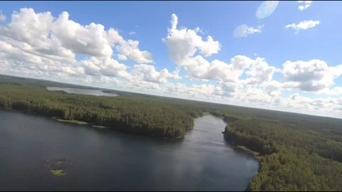 Fpv drone flight over blue lakes in a green forest over water Stock Footage 208609764