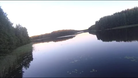 Fpv drone flight over blue lakes in a green forest over water Stock Footage 208609816