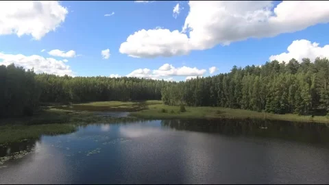 Fpv drone flight over blue lakes in a green forest over water Stock Footage 208609884