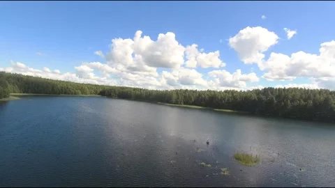 Fpv drone flight over blue lakes in a green forest over water Stock Footage 208610052