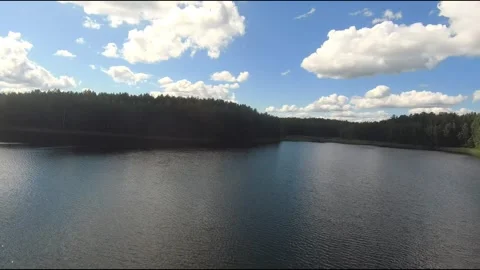 Fpv drone flight over blue lakes in a green forest over water Stock Footage 208610062