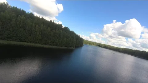 Fpv drone flight over blue lakes in a green forest over water Stock Footage 208610274