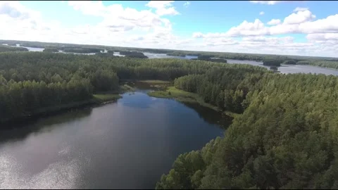 Fpv drone flight over blue lakes in a green forest over water Stock Footage 208610354