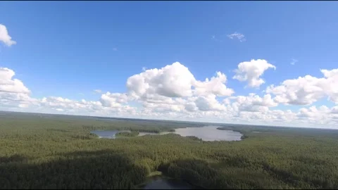 Fpv drone flight over blue lakes in a green forest over water Stock Footage 208610359