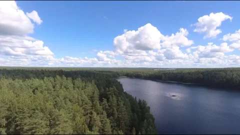 Fpv drone flight over blue lakes in a green forest over water Stock Footage 208610360