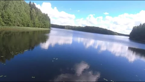 Fpv drone flight over blue lakes in a green forest over water Stock Footage 208610743