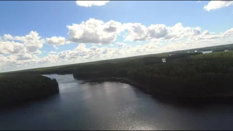 Fpv drone flight over blue lakes in a green forest over water Stock Footage 208610758