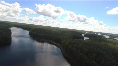 Fpv drone flight over blue lakes in a green forest over water Stock Footage 208610795