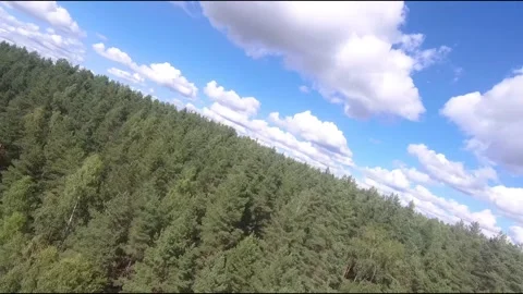 Fpv drone flight over blue lakes in a green forest over water Stock Footage 208611035