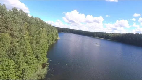 Fpv drone flight over blue lakes in a green forest over water Stock Footage 208611066