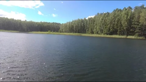 Fpv drone flight over blue lakes in a green forest over water Stock Footage 208611307