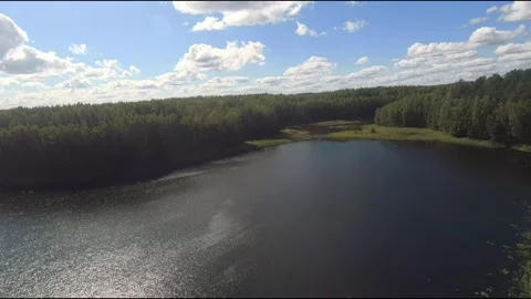 Fpv drone flight over blue lakes in a green forest over water Stock Footage 208611358