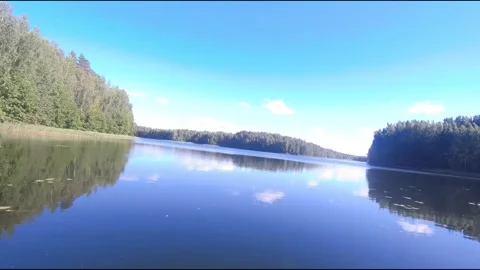 Fpv drone flight over blue lakes in a green forest over water Stock Footage 208611585