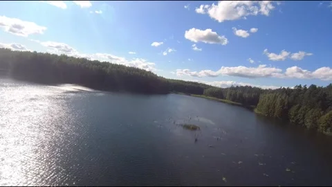 Fpv drone flight over blue lakes in a green forest over water Stock Footage 208611595