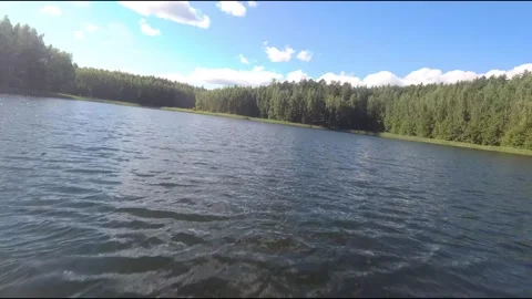 Fpv drone flight over blue lakes in a green forest over water Stock Footage 208611839