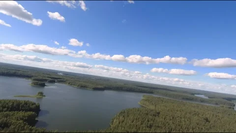 Fpv drone flight over blue lakes in a green forest over water Stock Footage 208611897