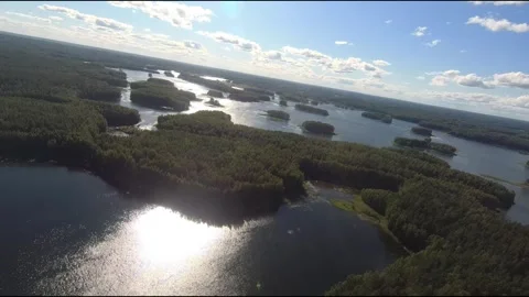 Fpv drone flight over blue lakes in a green forest over water Stock Footage 208611907