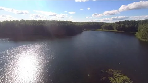 Fpv drone flight over blue lakes in a green forest over water Stock Footage 208612597