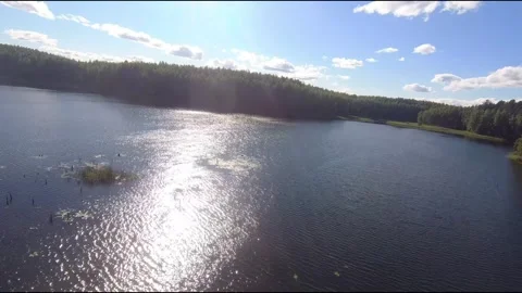 Fpv drone flight over blue lakes in a green forest over water Stock Footage 208612805