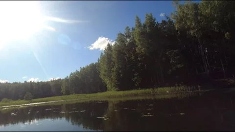 Fpv drone flight over blue lakes in a green forest over water Stock Footage 208612955