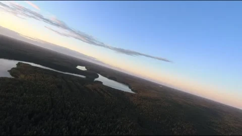Fpv drone flight over blue lakes in a green forest over water Stock Footage 208613252