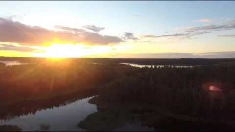 Fpv drone flight over blue lakes in a green forest over water Stock Footage 208613260