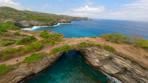 FPV drone flight over Broken Beach arch and turquoise lagoon on Nusa Penida Bali Stock Footage 310223178